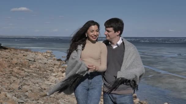 Young Couple Walk Rocky Shore Rock River Covered Ice Sunny — Stock Video