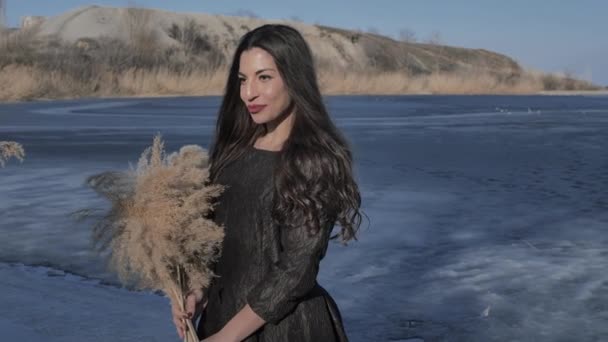 Młoda Kaukaska Dziewczyna Czarnej Sukience Trzyma Dłoniach Bukiet Trzciny Cukrowej — Wideo stockowe