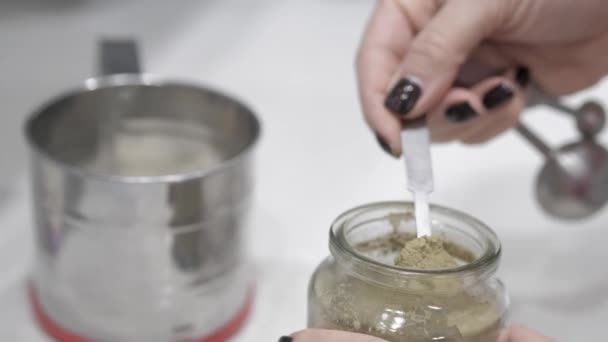 Female Hand Puts Gray Powder Measuring Spoon Iron Celendial Vessel — Stock Video
