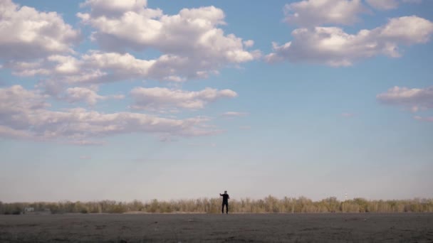 Man Dancing Distance His Face Visible Background Forest Cloudy Beautiful — Stock Video