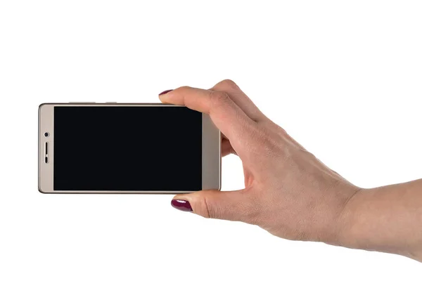 Жіноча рука тримає золотий кольоровий телефон — стокове фото