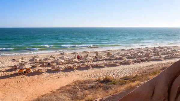 Sunbeds and umbrellas on the Falesia Beach — Stock Photo, Image