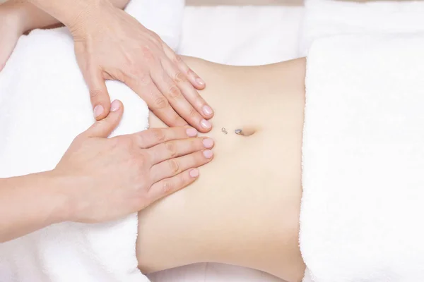 Massage Therapist Massaging a Womens Stomach. Massage and body care. Spa body massage woman hands treatment.