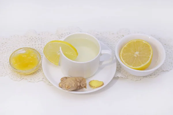 ginger tea with lemon and honey. Tea for immunity, a cold drink. ginger tea in a white cup on a white background. The concept of winter, health, immunity. A healthy detox drink.