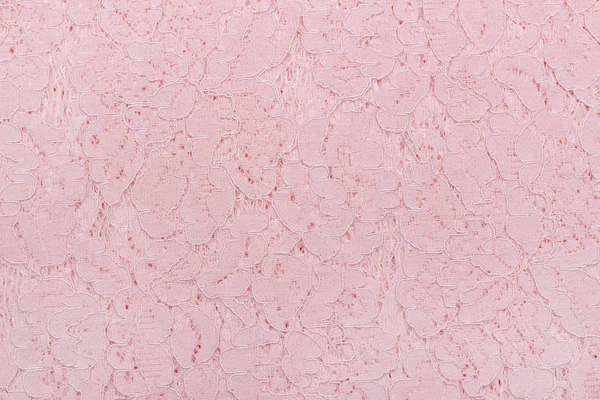 Background texture of lace fabric, delicate pink color. Beautiful luxury background. Smooth, lace elegant fabric.