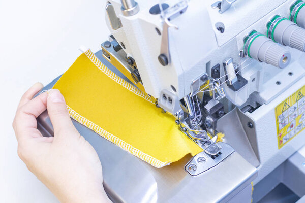 Sewing studio. Seamstress patch fabric. Overlock stitch. Overlock for sewing fabric. Tailoring