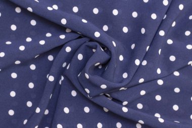 Koyu mavi arka planda beyaz benekli güzel kıvrımlı kumaş. kumaş arkaplan dokusu