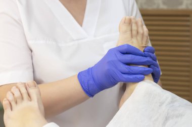 Kaplıcada ayak masajı, yakın plan. Ayak masajı, cilt bakımı. Tedavi edici pedikür..