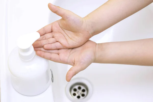 childrens hands are washed. children hand reaches for antibacterial soap. Protection against bacteria, coronavirus. hand hygiene.