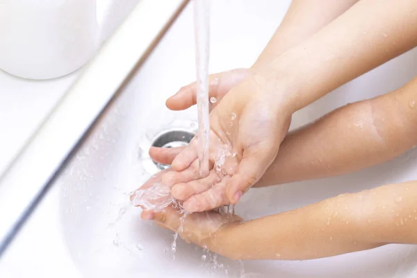 childrens hands are washed. childrens hand reaches for antibacterial soap. Protection against bacteria, coronavirus. hand hygiene.