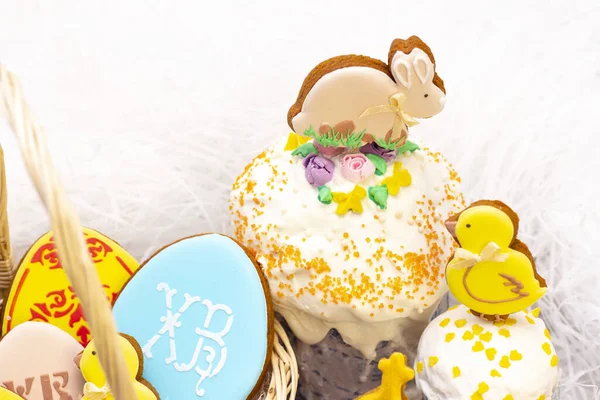 Easter holiday. Easter gingerbread chicken and rabbit on the Easter cake. on a light background. translation of Russian letters: CR (Christ is risen)