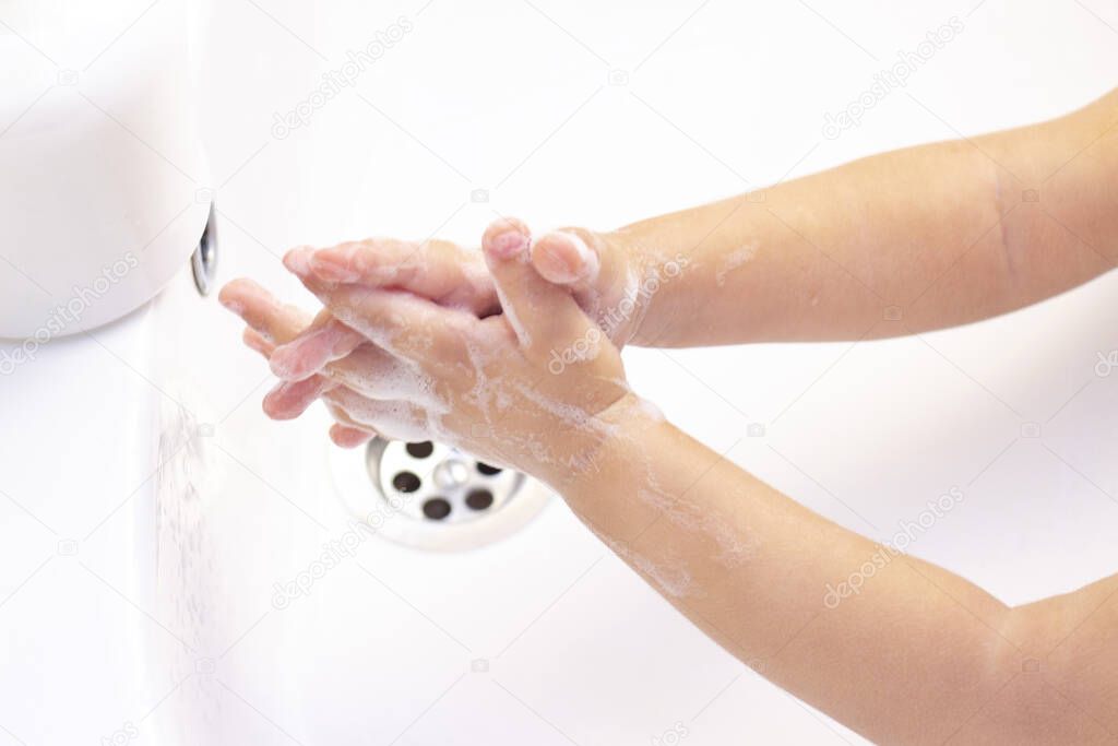 childrens hands are washed. childrens hands in foam from antibacterial soap. Protection against bacteria, coronavirus. hand hygiene. hand washing with water