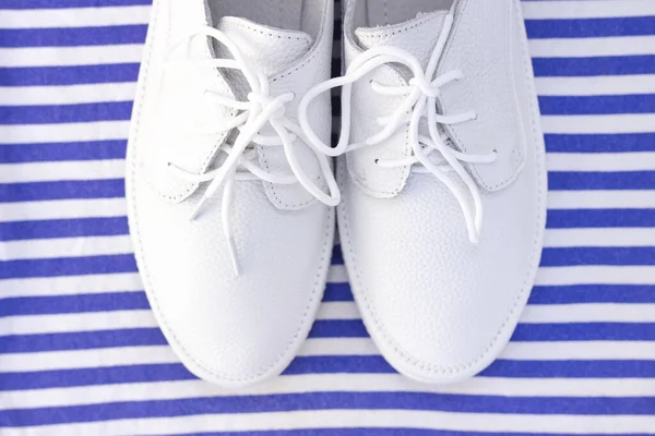 縞模様の白 青の背景に白いスニッカー トップビュー — ストック写真