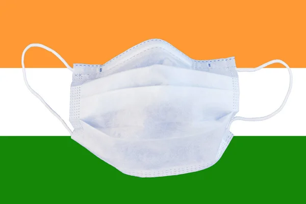medical mask on the India flag. Quarantine, coronavirus pandemic, isolation.