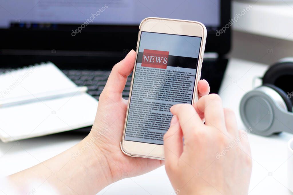 Online news on a mobile phone. Close up of businesswoman reading news or articles in a smartphone screen application. Hand holding smart device. Mockup website. Newspaper