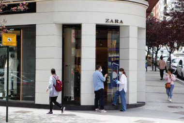 Coruna-Spain. Buyers in the first store opened by the 'Inditex' group, under the name 'Zara' after reopening today after being closed by the covid-19 on May 7, 2020 clipart