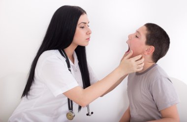 Female doctor examining boy clipart