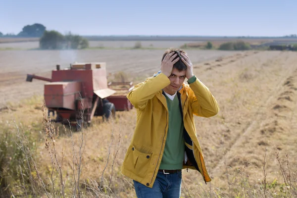 Unhappy farmer in soybean field — Stock Photo, Image