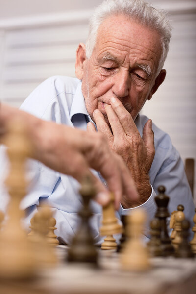 Senior men playing chess