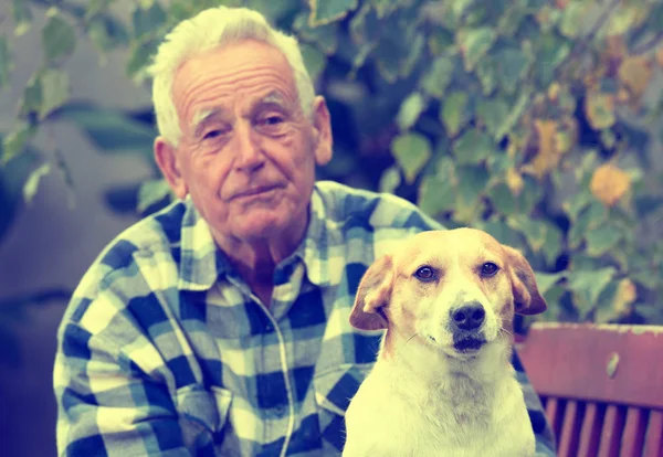 Starší muž se psem na nádvoří — Stock fotografie