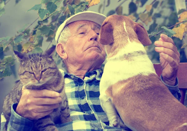 Senior man with pets — Stock Photo, Image