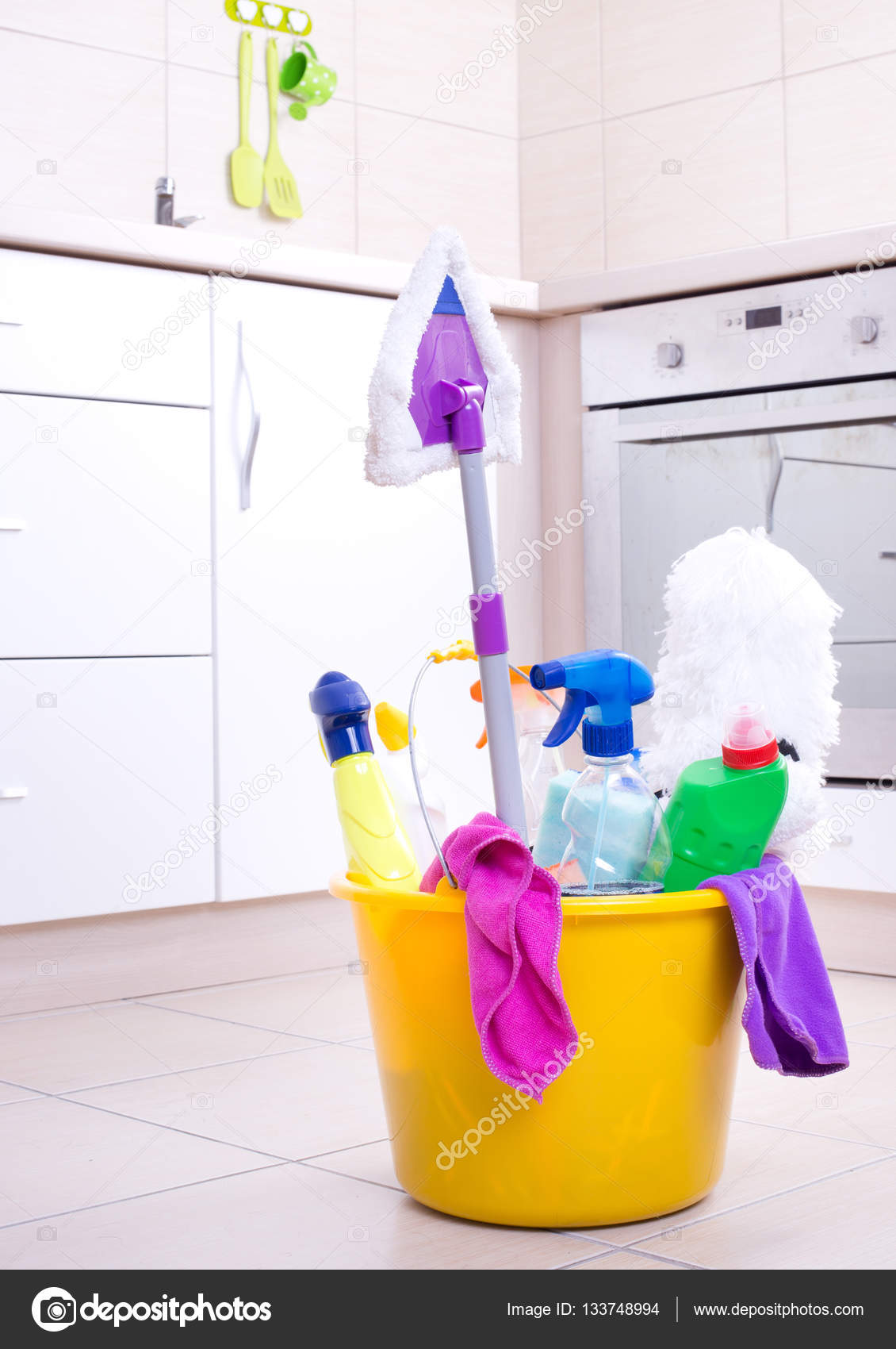 Cleaning Supplies In Bucket On Kitchen Floor Stock Photo Budabar Cleaning Supplies And Equipment In Bucket On Kitchen Floor With Oven Cabinets Background Photo By