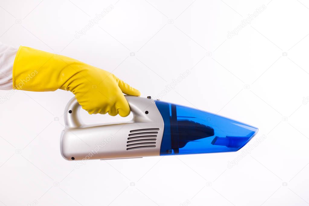 Maid holding vacuum cleaner on white