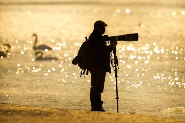 Nature photographer on river coast