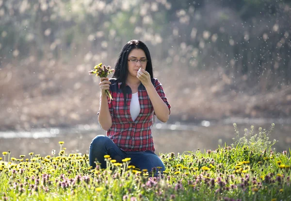 Girl with allergic reaction on flowers in field — Stock Photo, Image