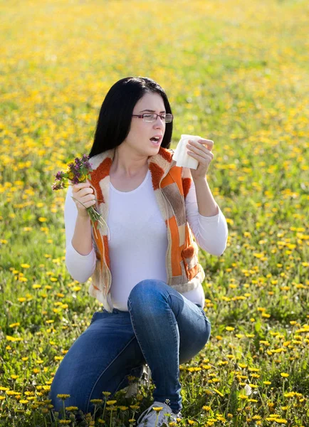 Girl with allergic reaction on flowers in field — Stock Photo, Image