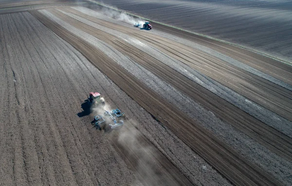 Tractors harrowing soil — Stock Photo, Image