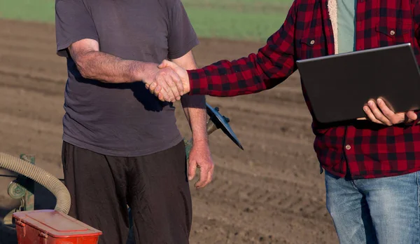 Farmář a inženýr potřesení rukou v oblasti — Stock fotografie