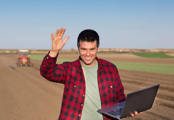 Ικανοποιημένοι αγρότης με laptop και τρακτέρ — Φωτογραφία Αρχείου