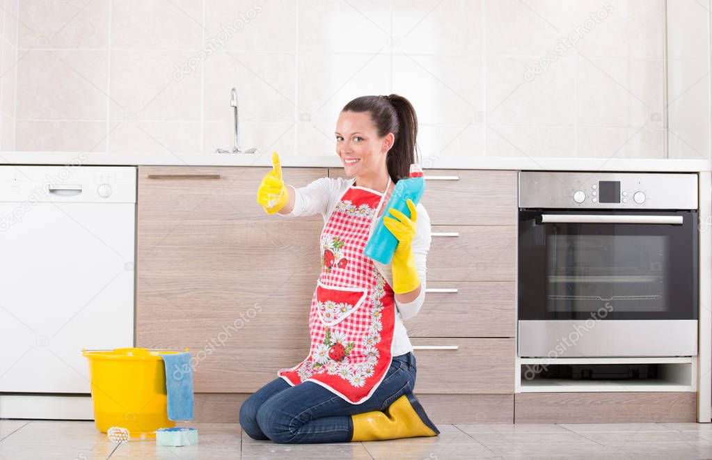 Cleaning lady showing bottle and thumb up