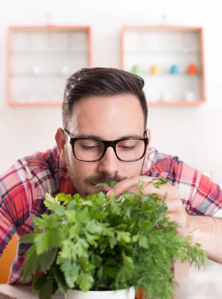 Man smelling frsh green spices — Stock Photo, Image