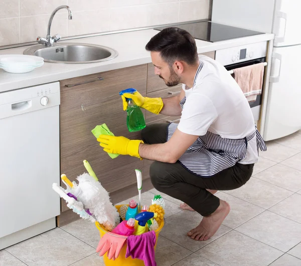 Hombre limpiando gabinetes de cocina — Foto de Stock