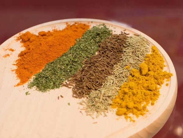 Spices on wooden board — Stock Photo, Image
