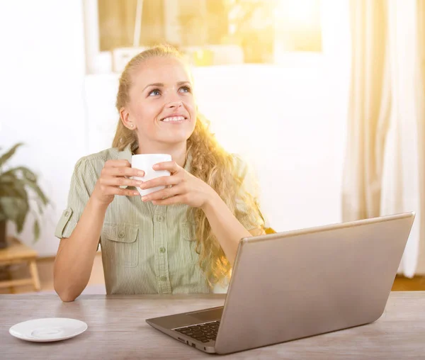 Young woman daydreaming in office — Stock Photo, Image