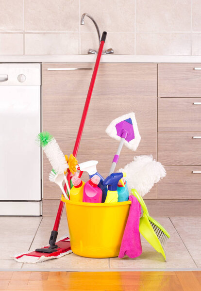 Cleaning products in bucket in kitchen
