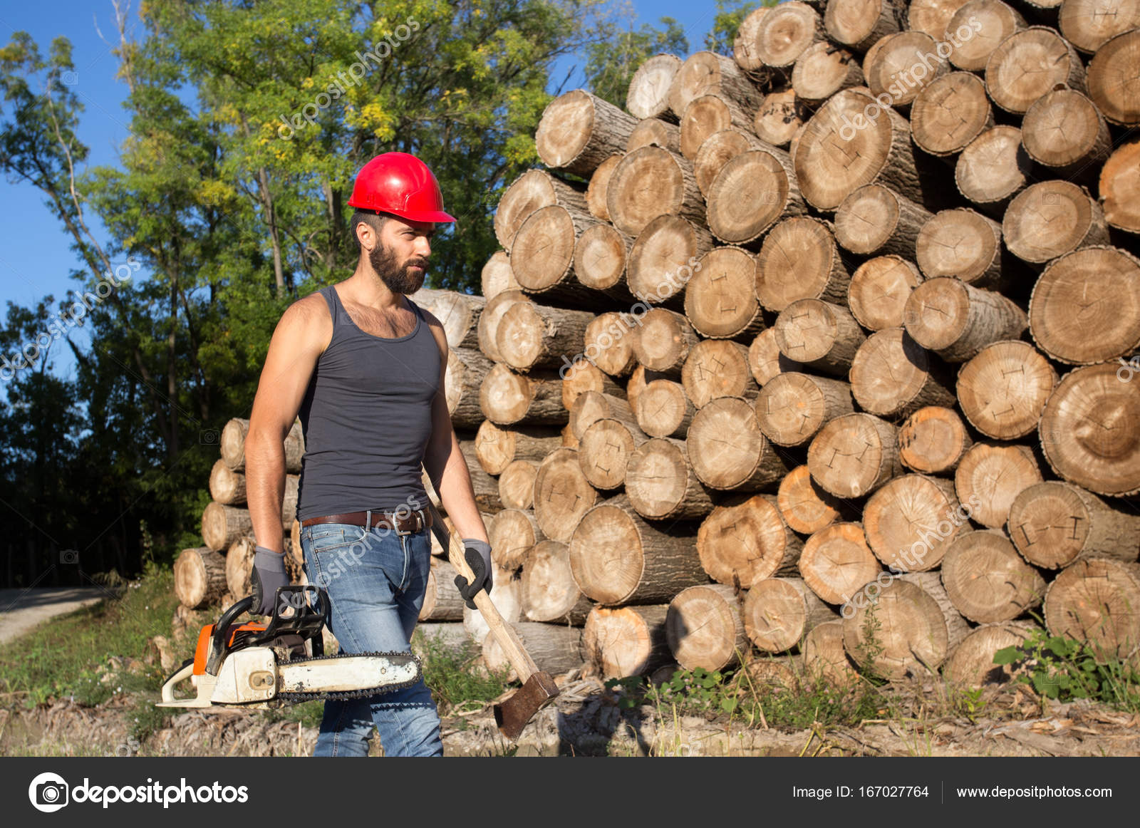 Lumberjack with chainsaw and ax in forest — Stock Photo © budabar