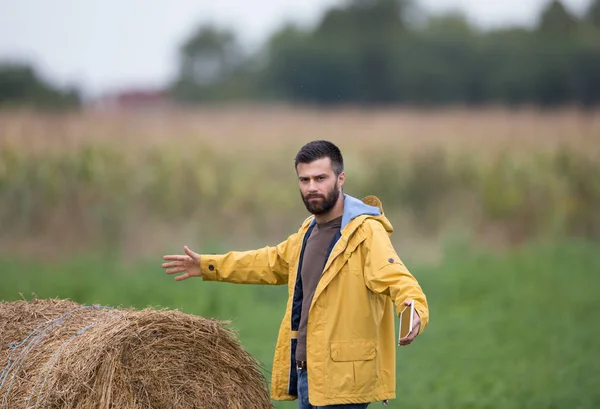 Farmer with rolled bale — Stock Photo, Image