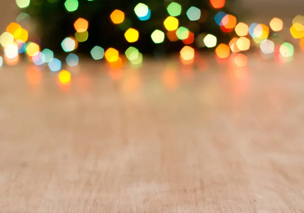 Empty table with Christmas lights in background — Stock Photo, Image