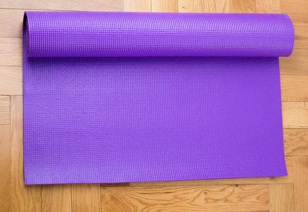 Yoga mat on parquet floor
