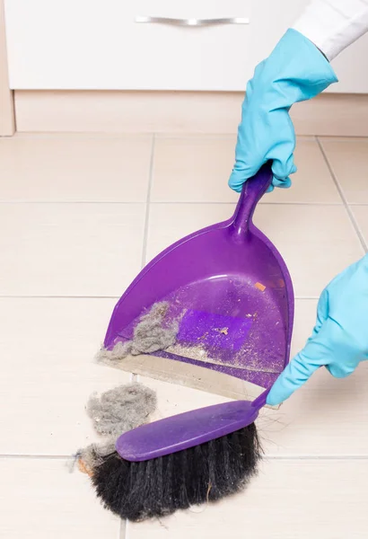 Sweeping tiled floor with brush and dustpan — Stock Photo, Image