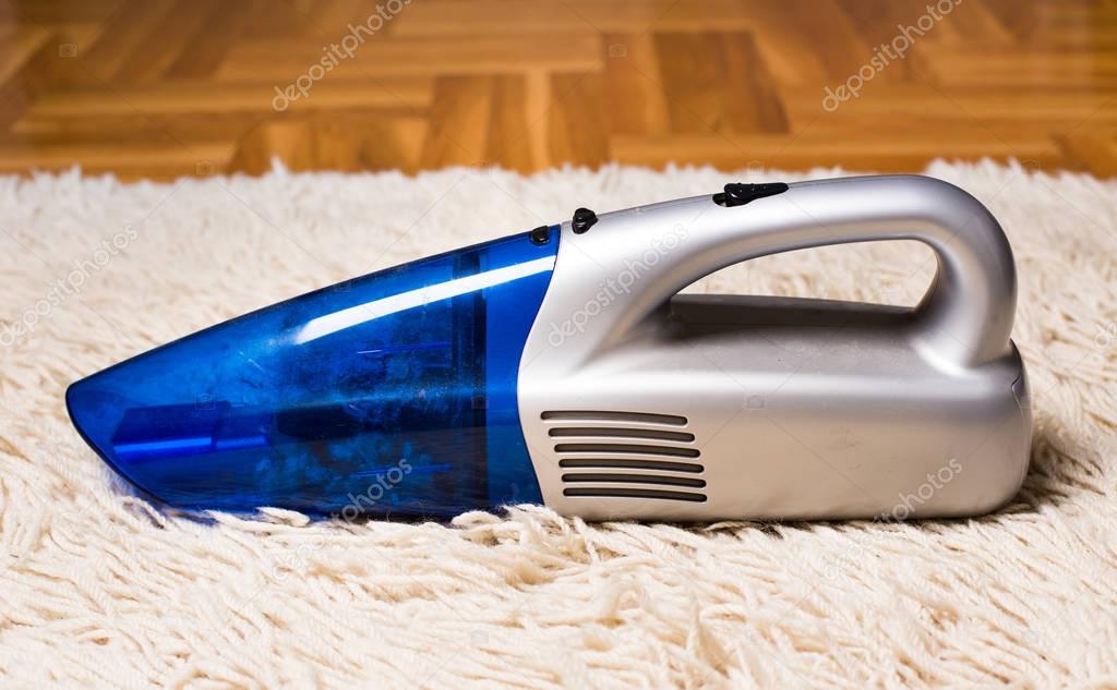 Handheld vacuum cleaner on carpet