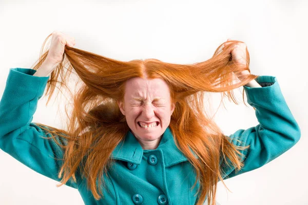 Stressed redhead girl on white background — Stock Photo, Image