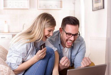 Genç çift internetten alışveriş yapıyor.