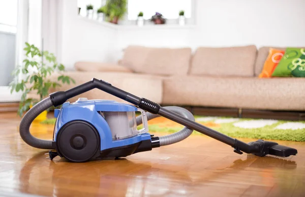 Vacuum cleaner on floor of living room — Stock Photo, Image