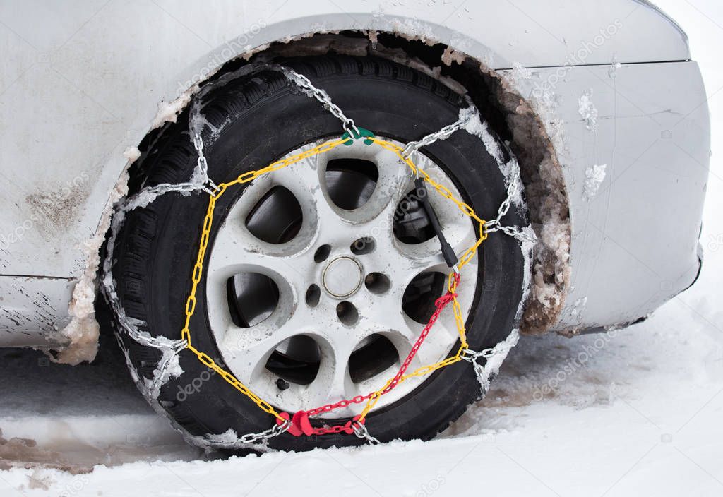 Tire chains on car in snow