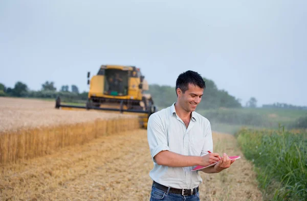 Happy Young Farmer Engineer Notebook Standing Wheat Field While Combine — Stock Photo, Image